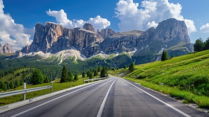 Fototapeta premium A mountainous landscape with a winding road stretching across the foreground, flanked by lush greenery and towering mountains in the background
