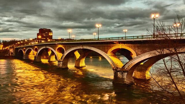 Timelapse Bridge of Catalans (Amidonniers Bridge) is Toulouse, France bridge crossing Garonne river. It is bridge in arch and stone and reinforced concrete inaugurated in 1908. Architect Paul Sejourne