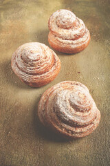 bakery product, lemon twist, with white glaze, sweet bun, muffin, pastries, top view, no people,