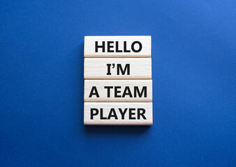 Hello I am a team player symbol. Concept words Hello I am a team player on wooden blocks. Beautiful deep blue background. Business and Hello I am a team player concept. Copy space