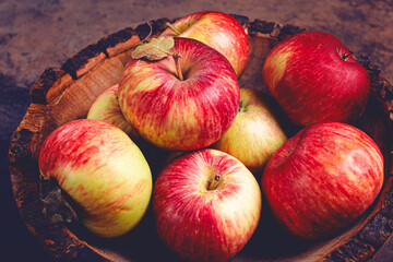 apples in a wooden bowl, top view, yellow - red, summer variety, early, no people,