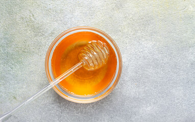 Fototapeta premium spoon with honey, on the table, spindle for honey, close-up, rustic view,