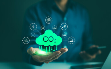 Carbon footprint concept. Man hand holding carbon reduction icon. Net zero and carbon neutral,...