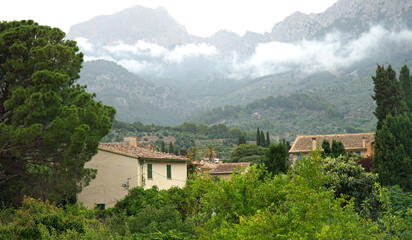 View of Soller Mallorca with low cloud in front of Tramuntana mountains 