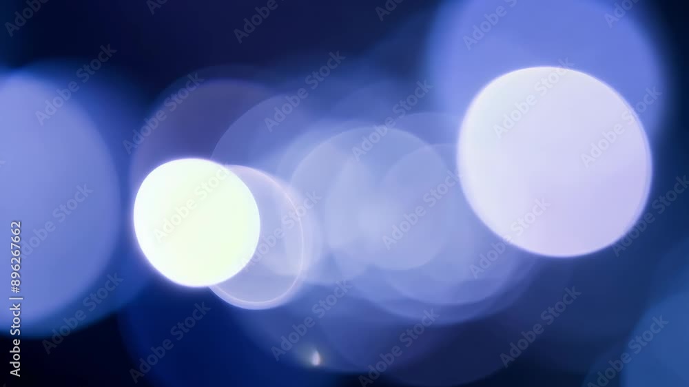 Poster a blurry blue background with a few circles in it. the circles are of different sizes and are scatte