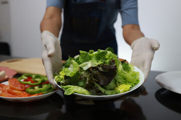 Women prepare ingredients and prepare breakfast sandwiches, fried eggs, and toast for the family