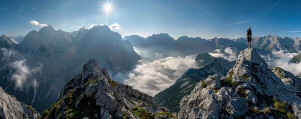 A wide-angle panorama of an alpine mountain landscape with dramatic peaks, clouds below and above the horizon, and in front there is a climber on top of a rock Generative AI