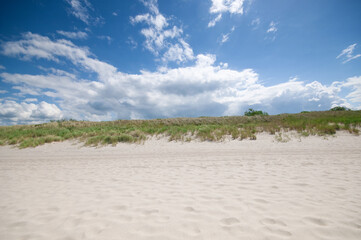 Sand dunes landscape against cloud blue sky