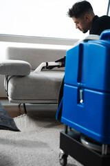 Refreshing sofa and cushions from dust and dirt with dry-cleaning extractor. Extracting dust and...