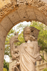 Zapopan, Jalisco, Mexico - June 7, 2024: Morning sun shines on a statue in the historic Arcos de Zapopan arch gateway.