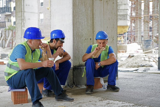 Construction industry concept architects and engineers discussing, lunch time