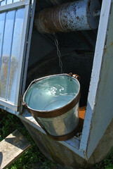 A well and a bucket of fresh spring water.