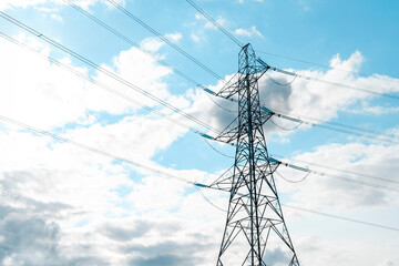 Tall Power Transmission Tower Against A Cloudy Sky