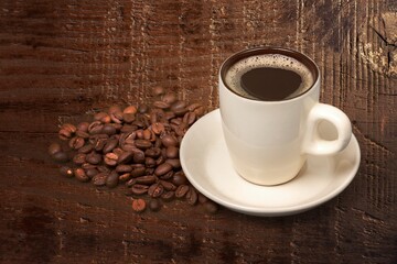 Cup of tasty hot coffee on wooden desk
