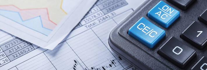 calculator and financial charts. Investment and capital accumulation concept