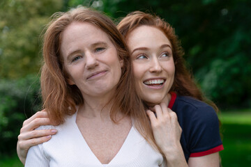 Fototapeta premium Two Redheaded Women Smiling in Park