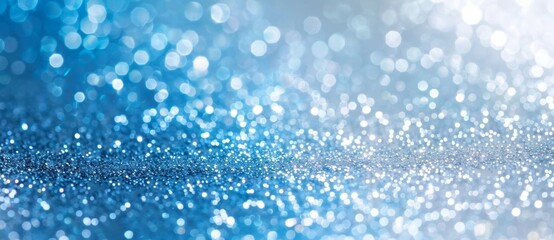 Creating an enchanting, magical atmosphere with abstract blue glitter and festive bokeh lights, perfect for celebrations and holidays like christmas and new year