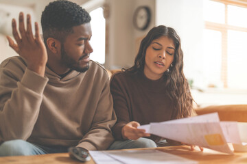 Young Couple Reviewing Finances at Home During Daytime