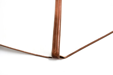 Close up of brown leather trim on white background