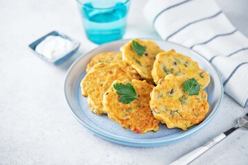 Corn fritters with cream sauce in a plate