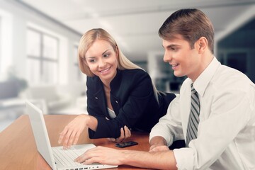 Two busy business colleagues working together