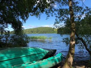 Fototapeta premium Canoes at a lakeside in the forest