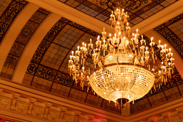 Elegant chandelier hanging from an ornate ceiling