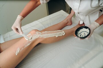 A woman receives a foot massage with peeling.