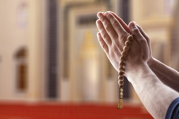 Muslim person praying on background, islamic concept