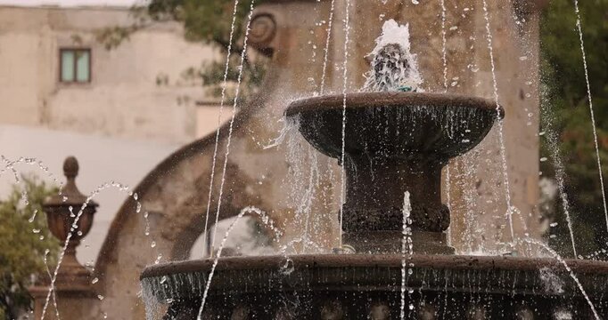 Morning view of the historic fountain and gateway arch of central downtown Zapopan, Jalisco, Mexico.