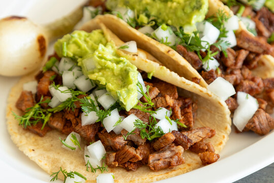 Close up of taco with carne asada or beef and guacamole
