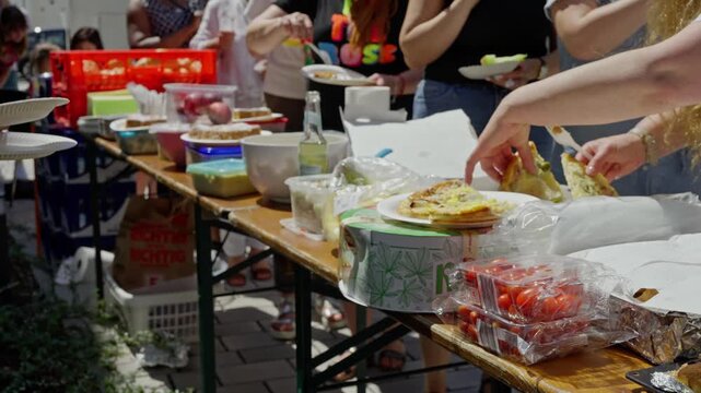 Outdoor Community Potluck with Various Homemade Dishes and Enthusiastic Participants