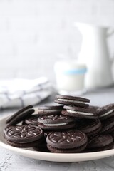 Many tasty sandwich cookies on light grey table