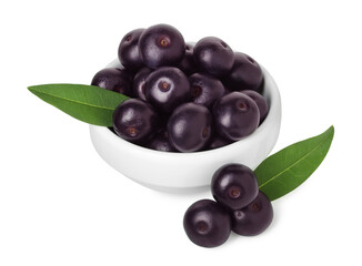Fresh ripe acai berries in bowl and green leaves isolated on white
