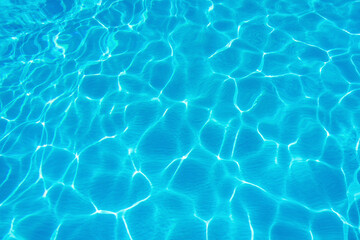 Ripples on the surface of the water in a blue swimming pool