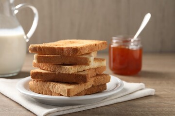 Slices of delicious toasted bread served on wooden table