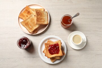Delicious toasted bread slices served on wooden table, flat lay