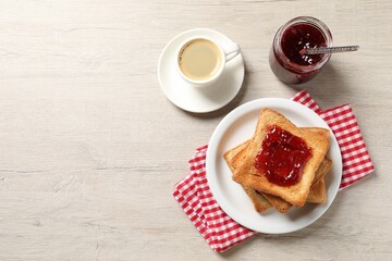 Delicious toasted bread slices served on wooden table, flat lay. Space for text