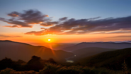Obraz premium a-serene-sunset-scene-with-the-sun-setting-behind-a-mountain-range-casting-a-warm-glow-over