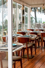 Interior of a modern restaurant with tables and chairs, nobody inside