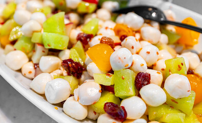 Salad with mozzarella cheese and fruit.