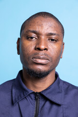 Obraz premium Portrait of cheerful confident security guard feels proud of his duties, working on ensuring safety and protection on premises. African american guard in uniform smiling on camera. Close up.