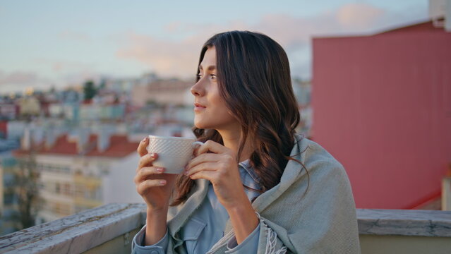 Tender woman drinking espresso sunset town view balcony closeup. Girl relaxing