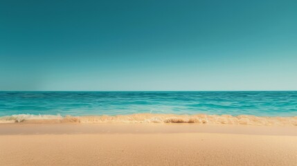 Obraz premium Turquoise blue water meets the golden sand of a pristine beach with a clear sky above, offering a serene and inviting summer vacation vibe