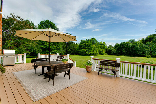Spacious Backyard Deck With Outdoor Furniture And Umbrella For Relaxation