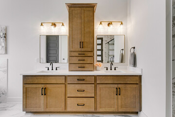 Double Vanity Bathroom With Storage Cabinets And Marble Accents