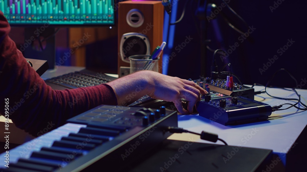 Poster Sound engineer recording and producing audio for music industry, operating on mixing console and daw software in home studio. Musician ensuring optimized acoustics, mastering tracks. Camera A.