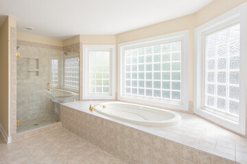 Luxurious Bathroom With Soaking Tub And Glass-Enclosed Shower In Light Setting