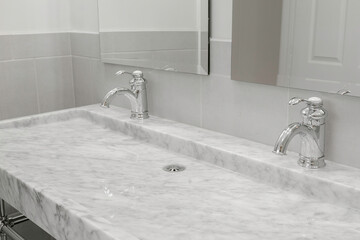 Elegant Marble Double Sink In Modern Bathroom With Chrome Faucets And Mirrors