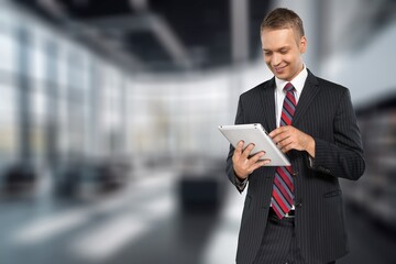 Portrait of confident business man with digital tablet.